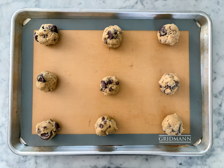 Balls of rolo cookie dough on a tray
