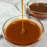 Drizzling caramel sauce into a bowl