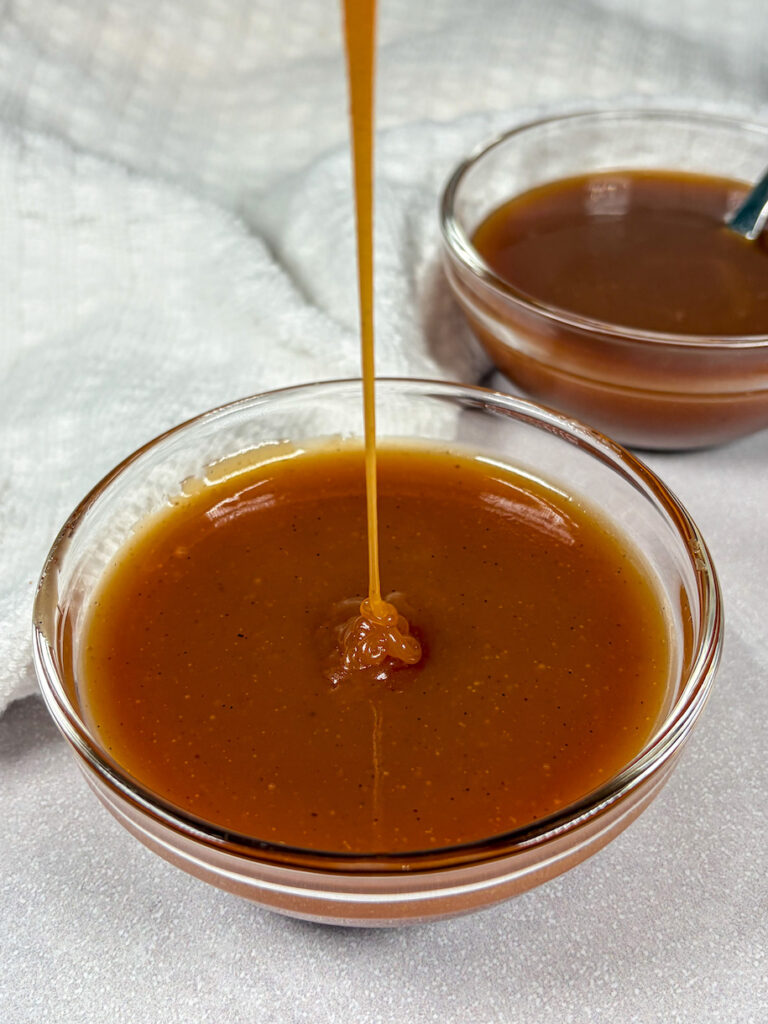 Drizzling caramel sauce into a bowl