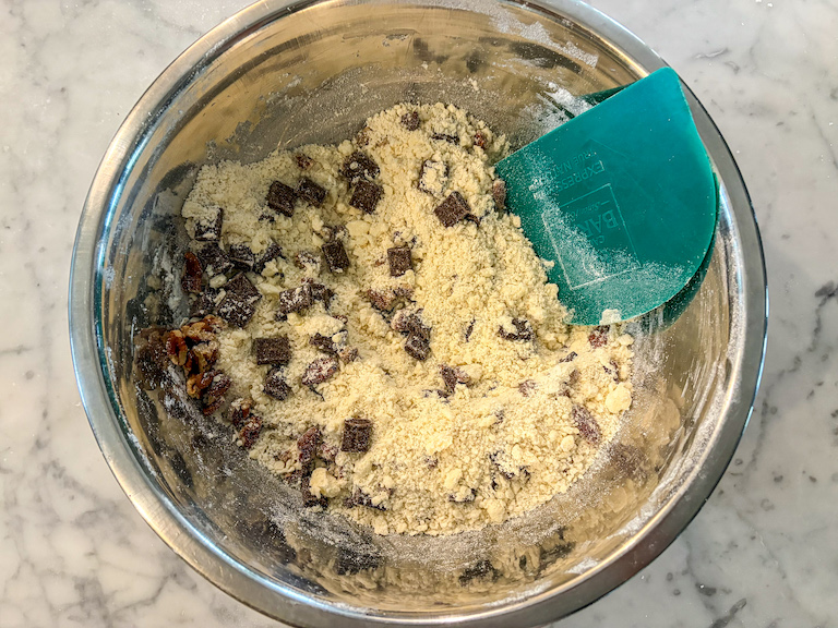 Mixing shortbread dough with a bench scraper