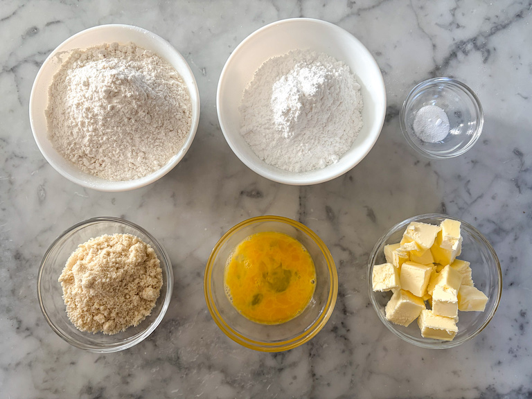Miniature lavender tart recipe ingredients on a marble surface