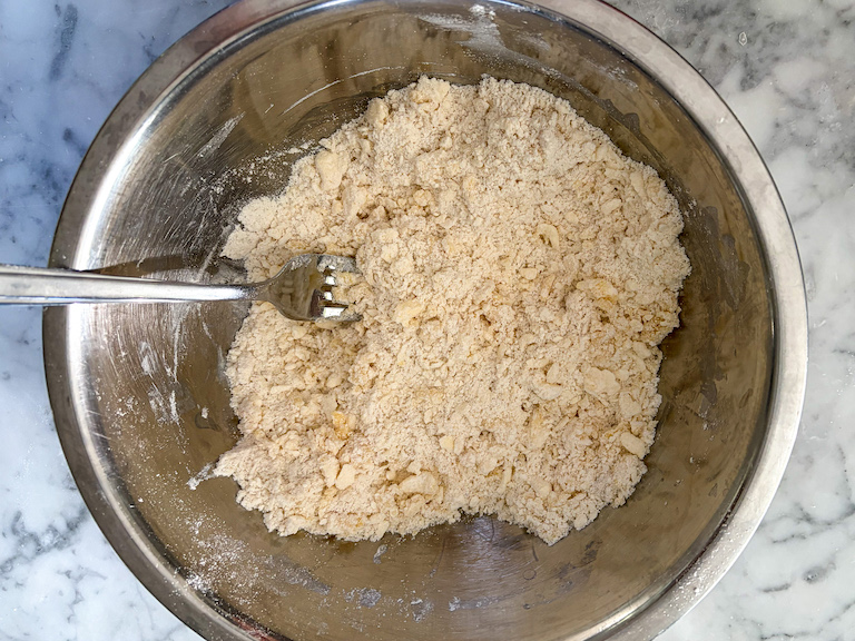 Fork mixing pastry in a bowl