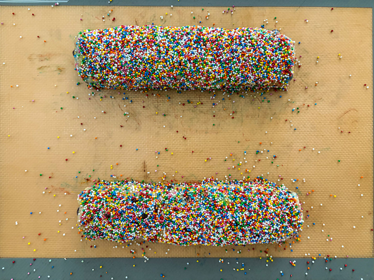 Biscotti dough logs coated in nonpareil sprinkles