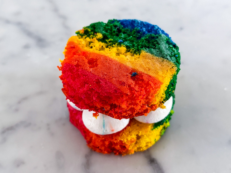 Assembling a mini dot cake on a marble surface