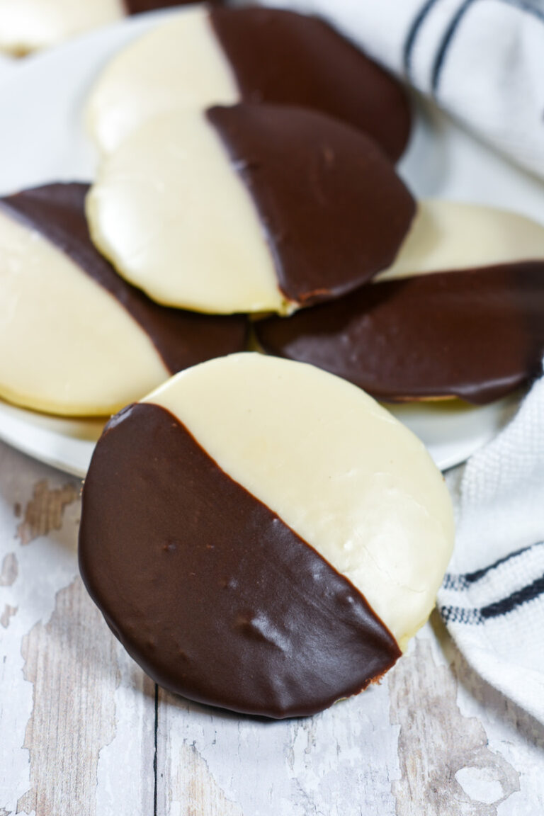 new york black and white cookies on a white plate