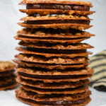 a stack of oatmeal lace cookies with chai chocolate ganache filling