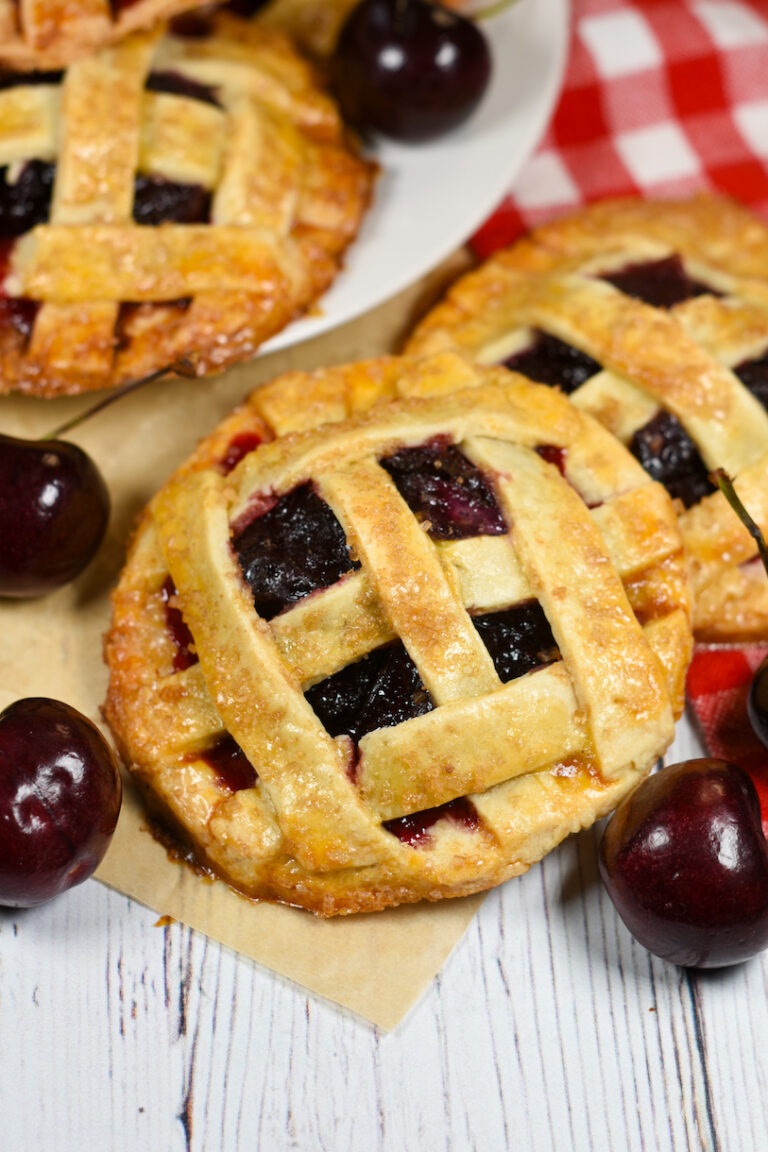 A recipe and instructions for making individually sized cherry pies with homemade pastry, a cherry apple filling, and a lattice top.