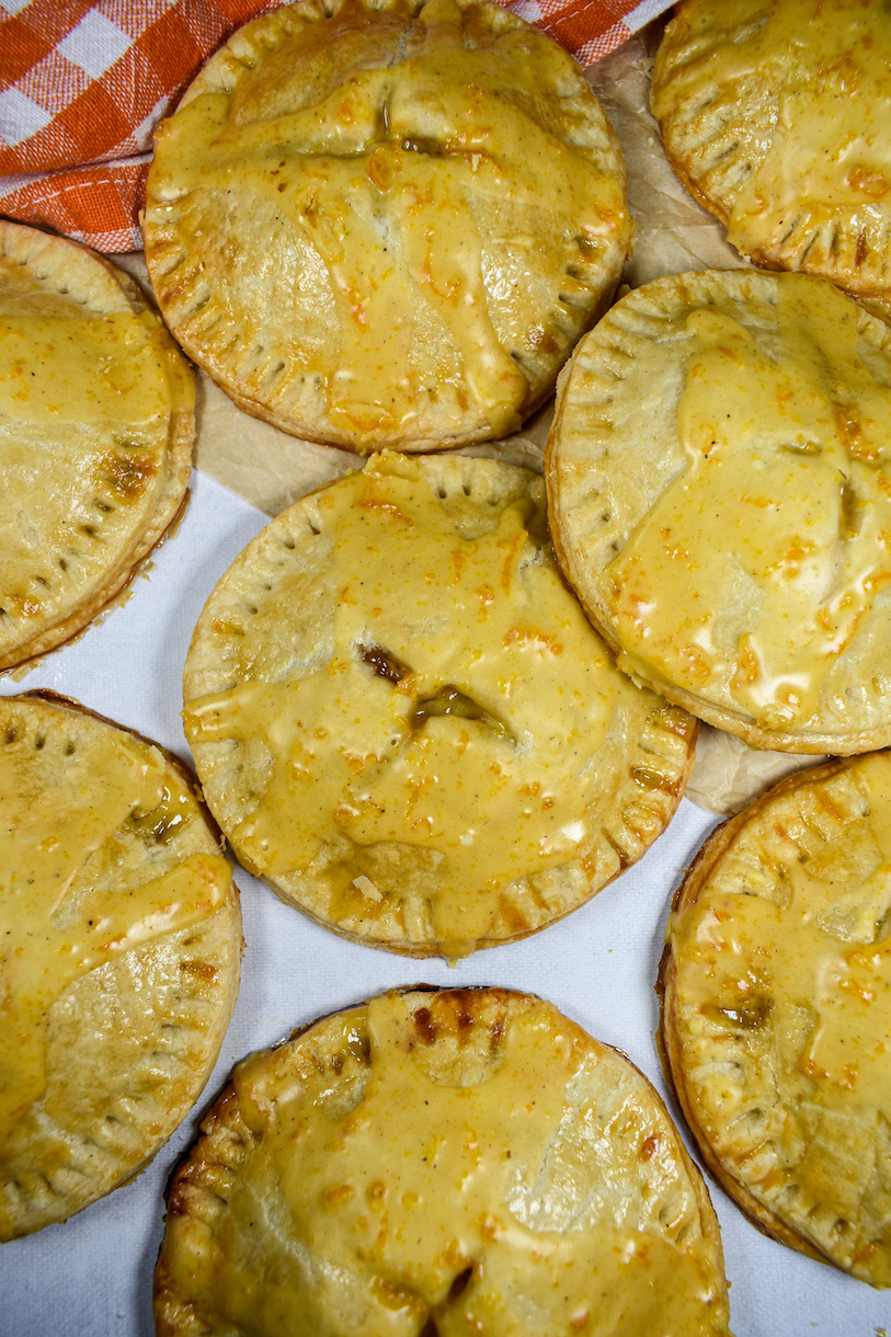 Peach hand pies arranged on a white surface