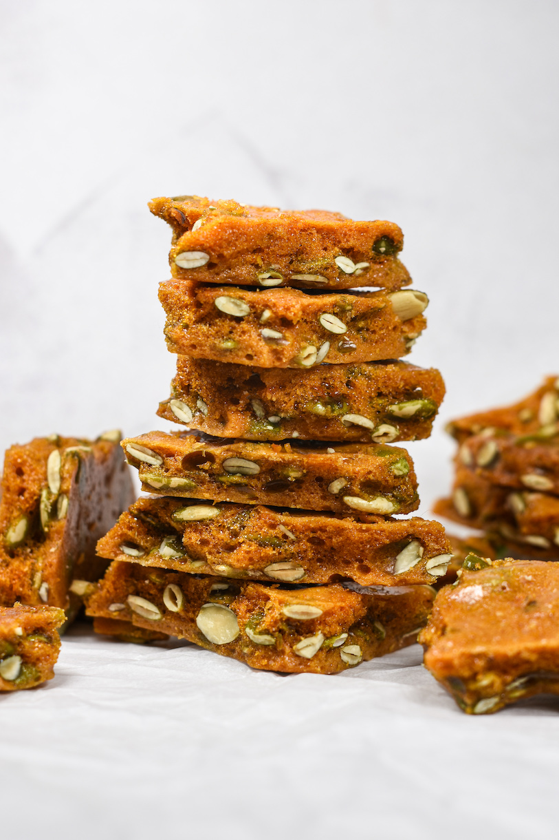 a stack of pepita brittle pieces on a white surface