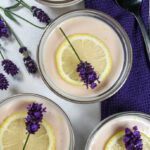 Lavender lemon possets garnished with lemon slices and fresh lavender flowers