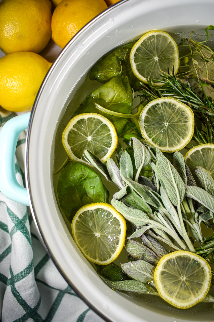 fresh herbs and lemon slices in an herb garden inspired simmer pot