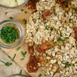a loaf of cheddar and herb soda bread on a wooden cutting board