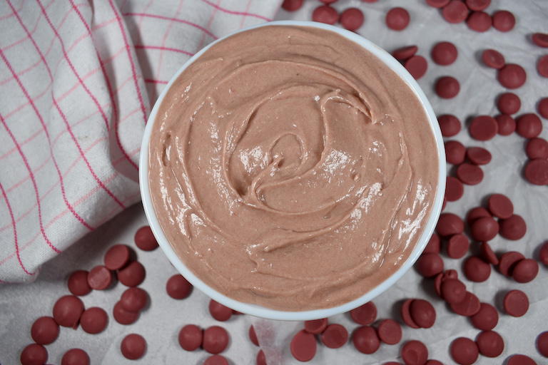 a bowl of ruby chocolate ganache with ruby callets