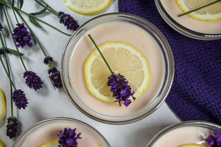 lavender lemon posset garnished with a slice of lemon and a sprig of fresh lavender
