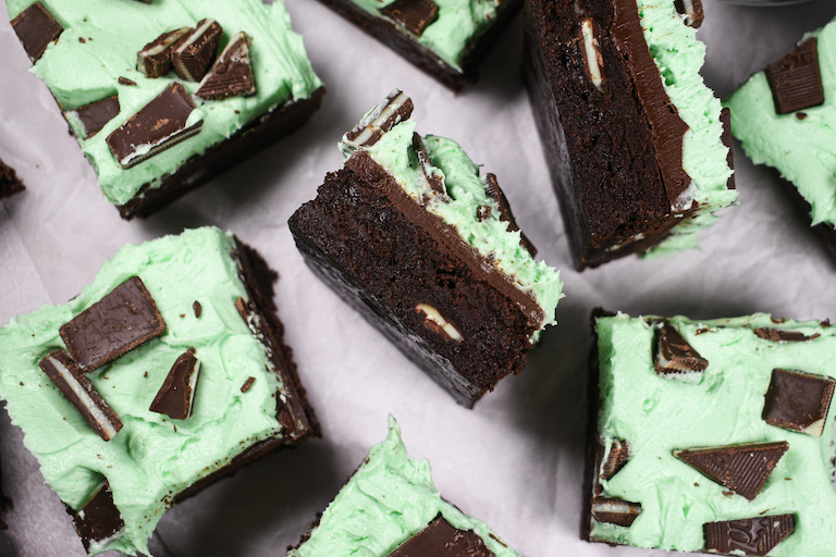 Buttercream mint brownies arranged on a white surface