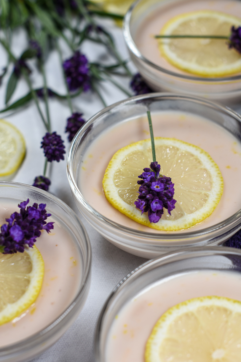 lavender lemon posset with lavender flowers and sliced fresh lemon