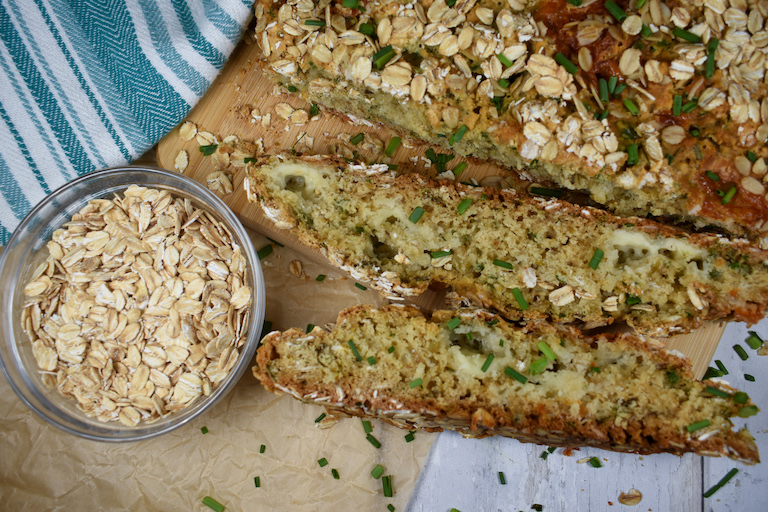 sliced loaf of soda bread with a dish of oats