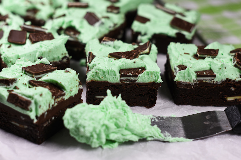 Chocolate mint brownies and a palette knife of mint green buttercream frosting