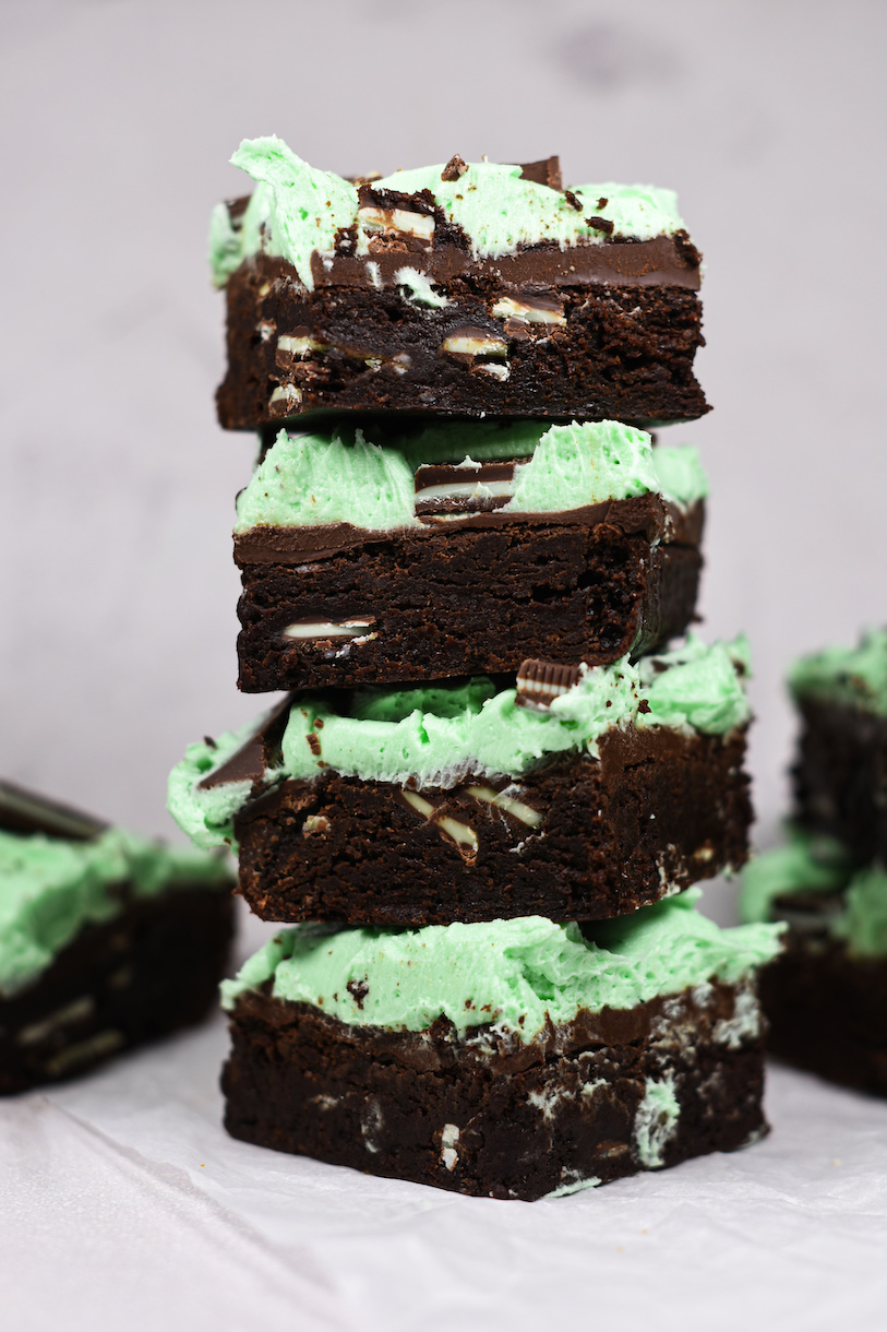 A stack of four chocolate mint buttercream brownies