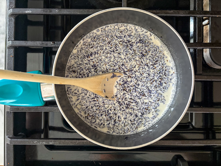 stirring together cream and dried lavender in a small pan on the stovetop