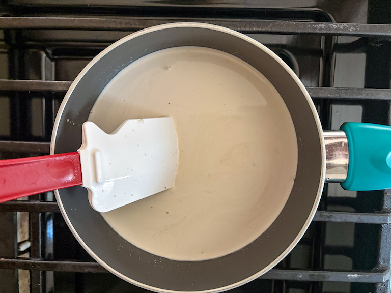 stirring together cream and lemon in a saucepan