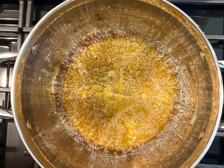 honey colored sugar syrup in a stock pot