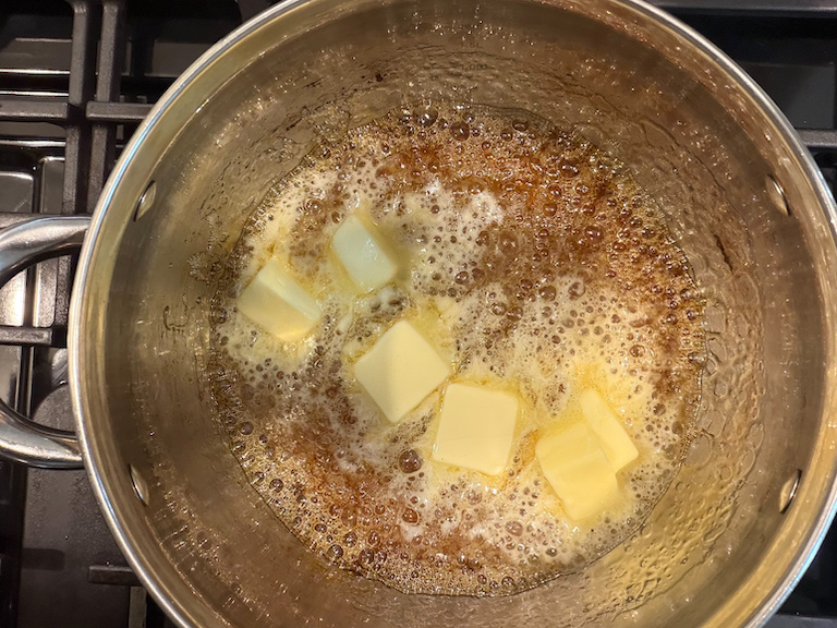 adding butter to sugar syrup