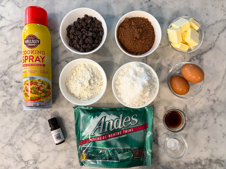 Ingredients for making mint brownies, arranged on a marble surface