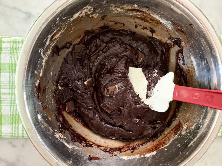 chocolate mint brownie batter in a bowl with a spatula