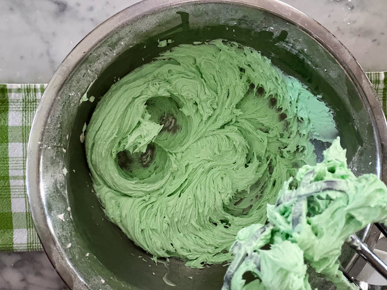 A bowl of mint green buttercream frosting