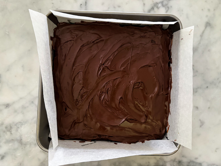 A pan of brownies with chocolate frosting