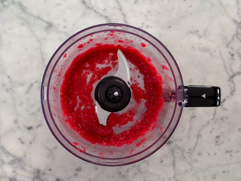 puréed raspberries in a food processor