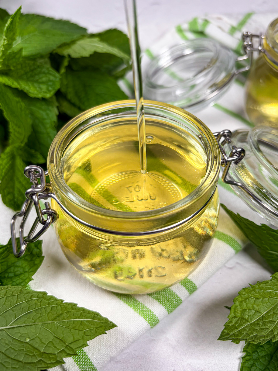 mint syrup drizzling into a jar