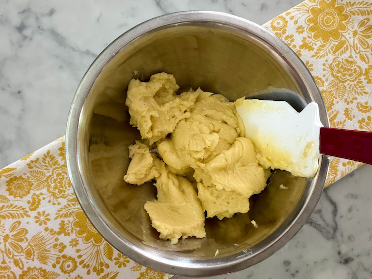 pastry cream in a bowl with a rubber spatula