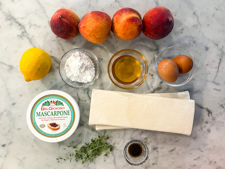 Mascarpone peach puff pastry recipe ingredients on a marble surface