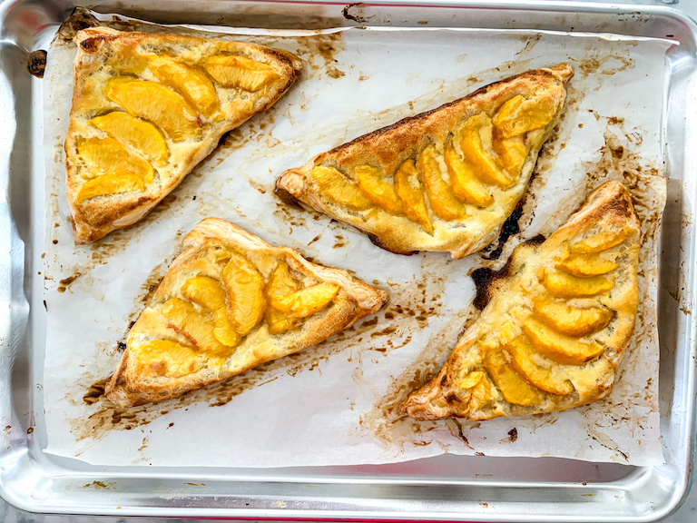 A tray of peach and mascarpone puff pastries