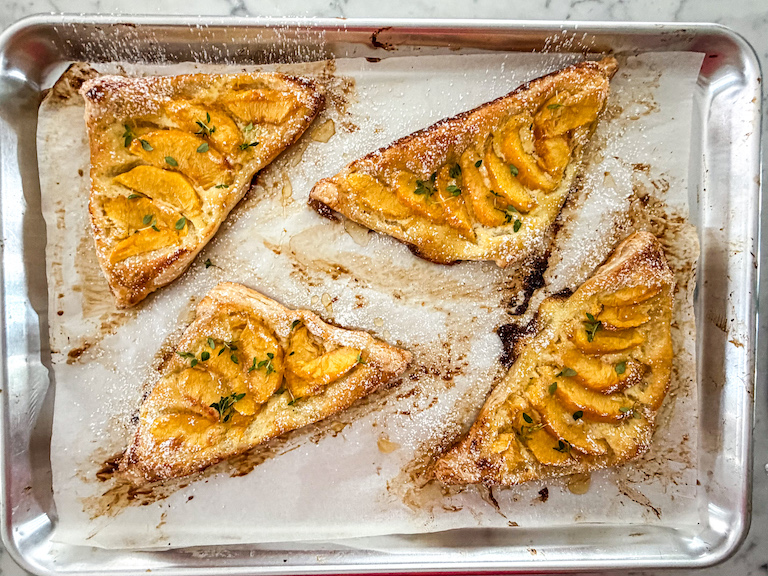 peach and mascarpone pastries on a tray after baking