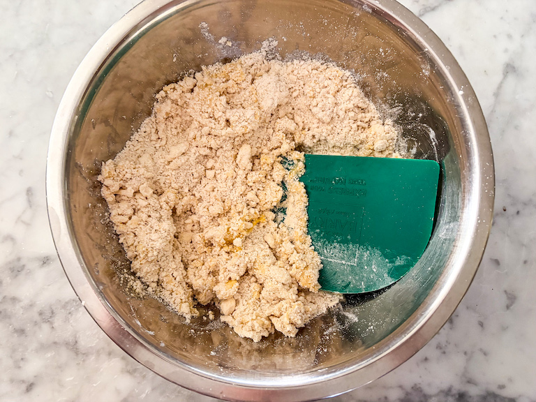 pastry blender blending a bowl of shortcrust pastry
