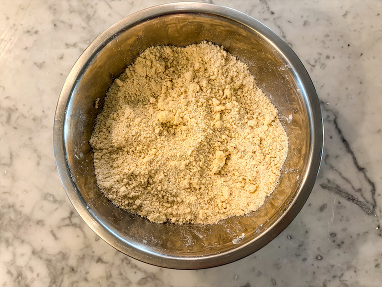 crumbled butter and dry ingredients in a metal bowl