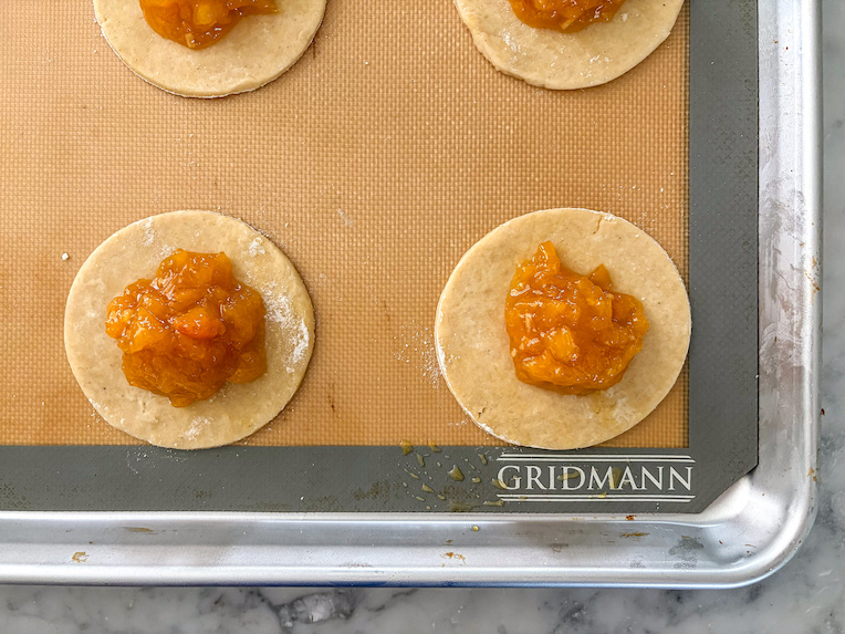 discs of pastry with peach jam spooned in the middle