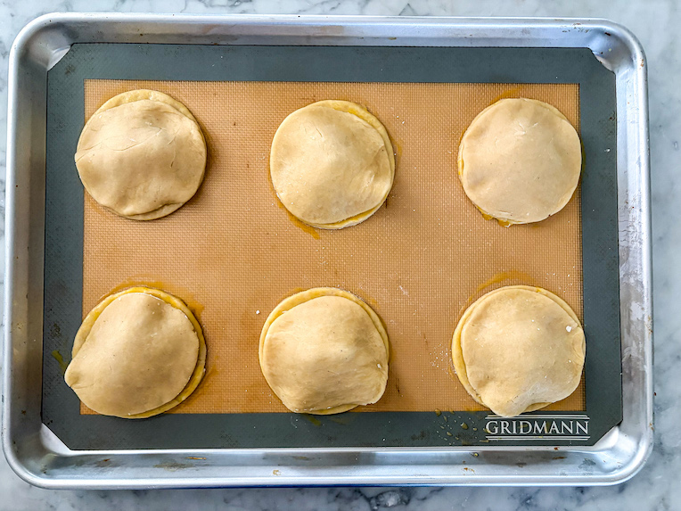 Discs of pastry on a baking tray