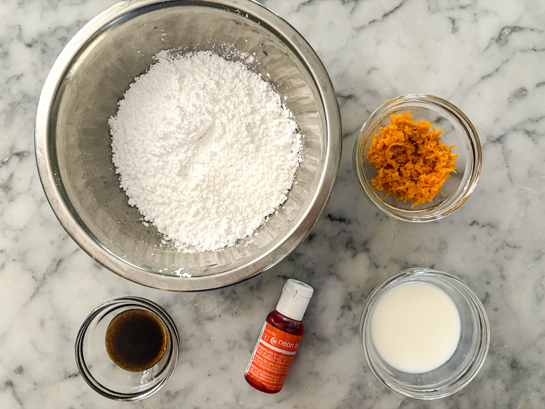 orange glaze ingredients arranged on marble surface