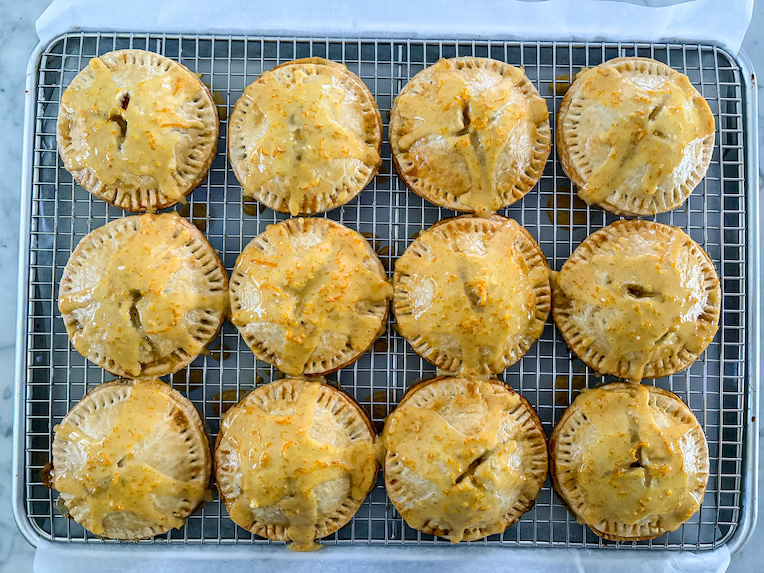 glazed peach hand pies on a wire rack