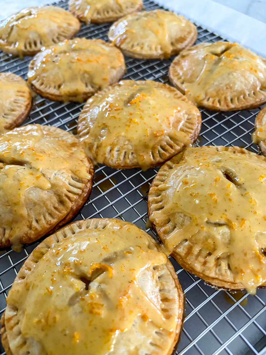 Peach hand pies cooling on a wire rack