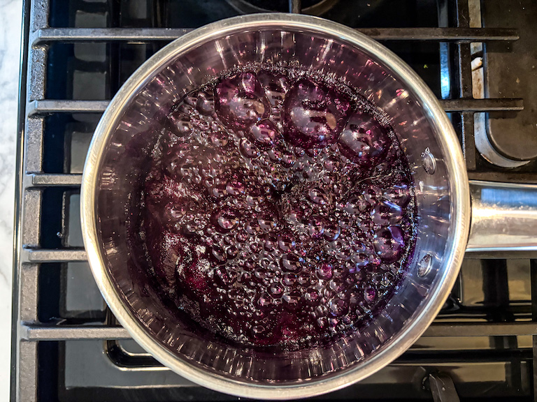 blueberry jam simmering on the stovetop