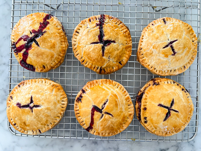 blueberry hand pies cooling on a wire rack