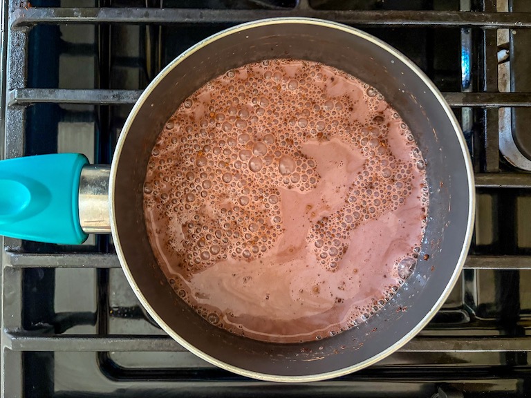 Chocolate and milk simmering in a pan on the stovetop