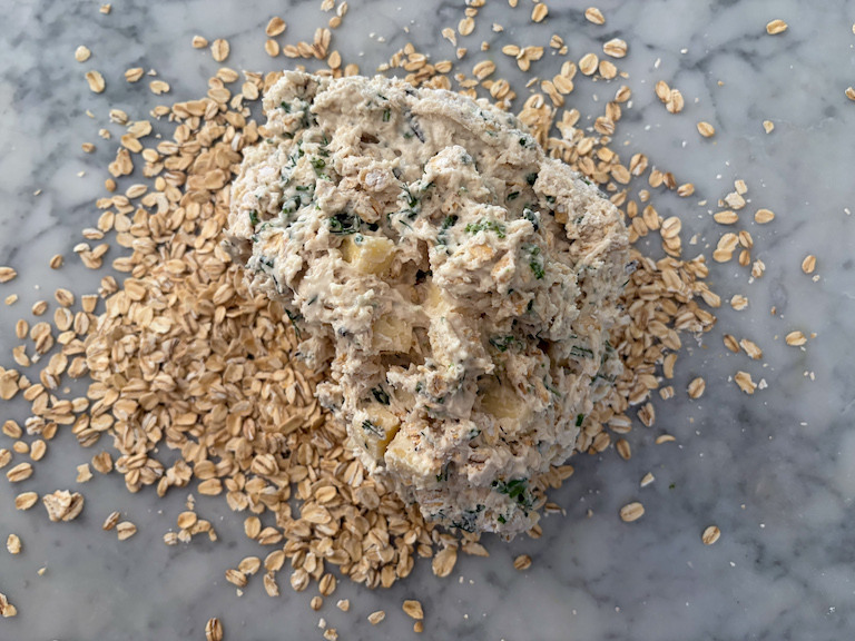 rolling soda bread dough in oats