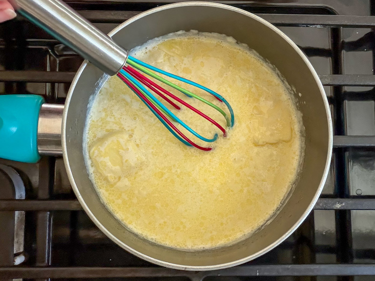 whisking cream and butter in a small pan