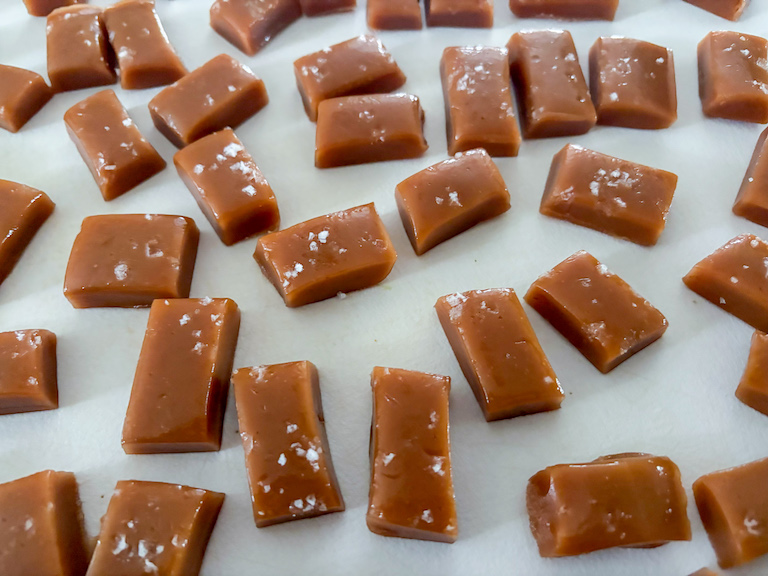 salted rosemary caramels on a white surface